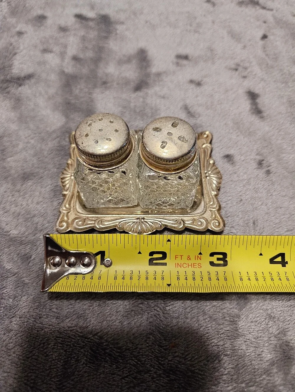 Vintage mini crystal glass salt and pepper shakers with a diamond pattern.